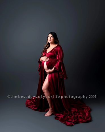 a beautiful pregnant woman in a maroon dress 