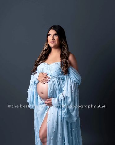 a pregnant woman in a blue dress 