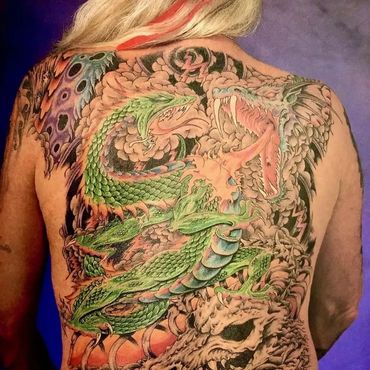 Intricate green dragon tattoo covering the entire back.