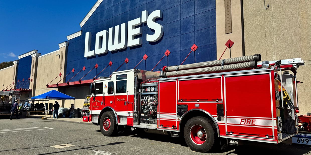Fire truck parked outside a Lowe's store on a sunny day.