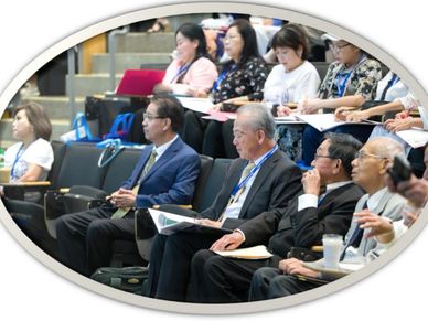 Audience attentively listening at a formal conference or seminar.