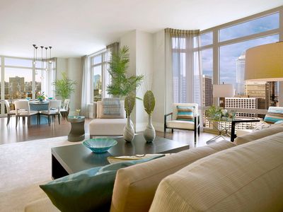 Modern living room with large windows and city views.
