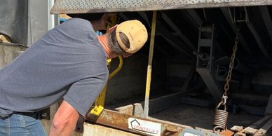 Man inspecting a loading dock lift in a warehouse.