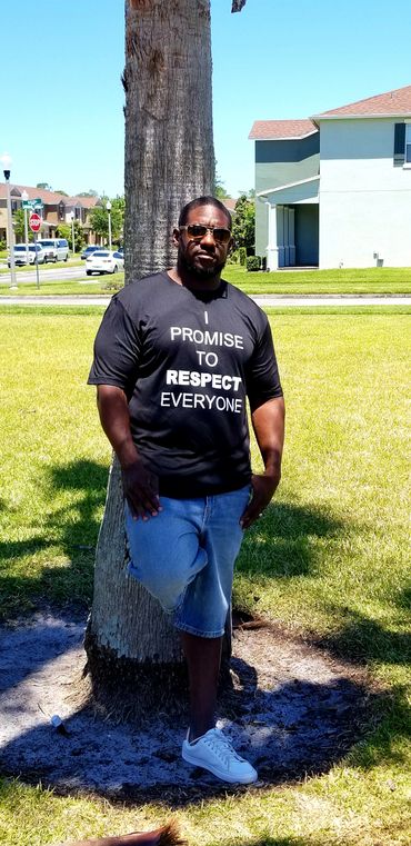 alt="Christian man and husband wearing sunglasses and modeling a black Promise Principles t-shirt"