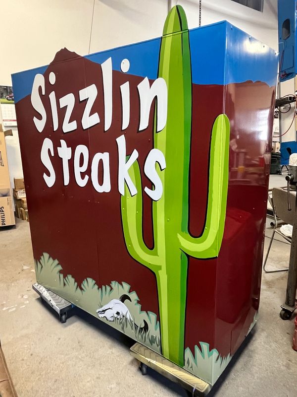 A colorful box with 'Sizzlin Steaks' and a cactus illustration.