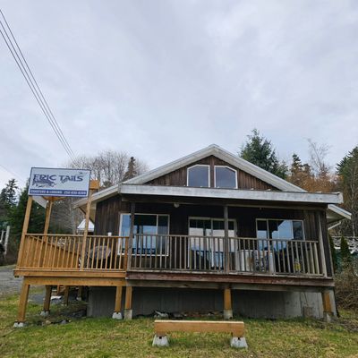 Rustic wooden lodge named Eric Tails offering charters and lodging.