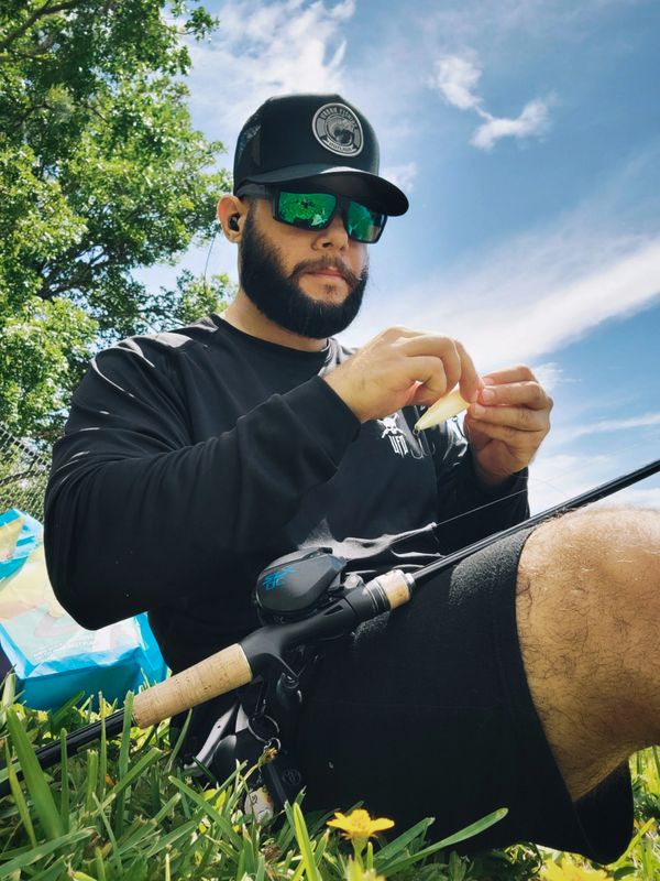 Fishing shirt and fishing hat tying a fishing lure.