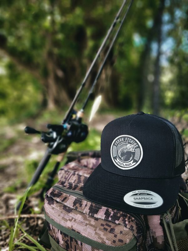 Fishing hat and fishing rod ready for fishing adventure