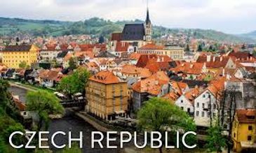 Scenic view of a historic town in the Czech Republic with a river and colorful rooftops.