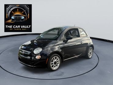 Black Fiat 500 displayed in a studio with The Car Vault logo.