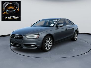 Sleek gray Audi sedan displayed in a modern showroom.