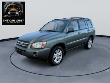 Green Toyota Highlander SUV parked on a rotating platform with The Car Vault logo.