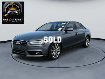 Sleek gray Audi sedan displayed in a modern showroom.