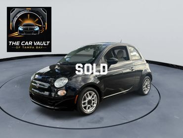 Black Fiat 500 displayed in a studio with The Car Vault logo.