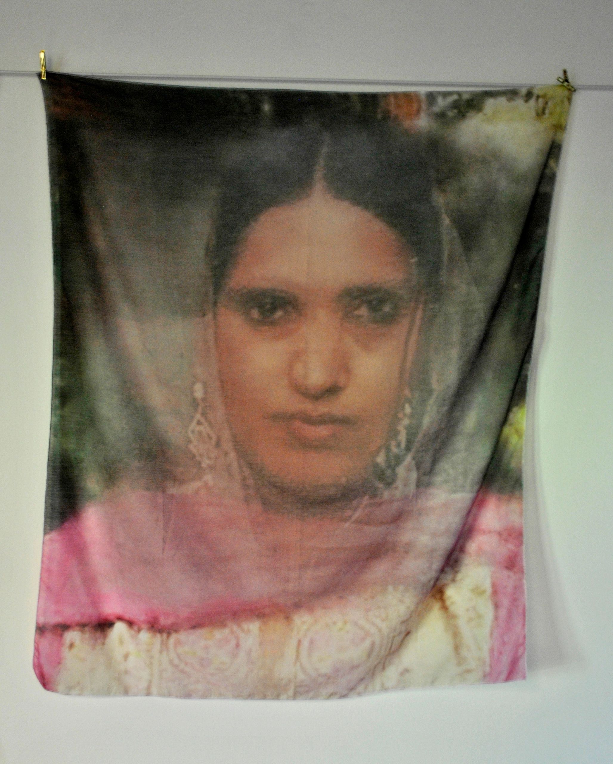 Painting of a woman with earrings and veil.