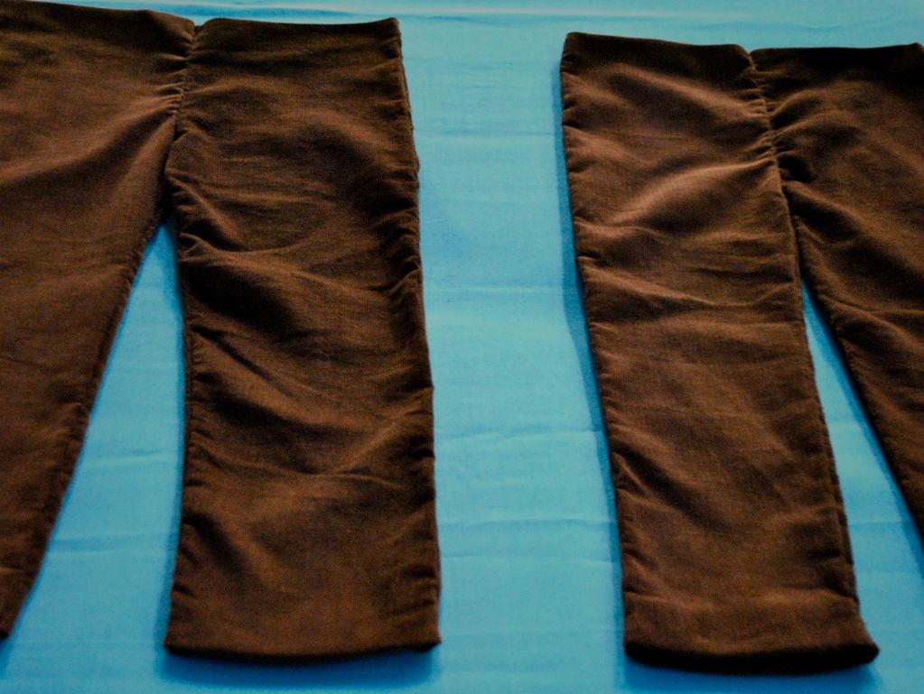 Two brown pant legs on a blue surface.