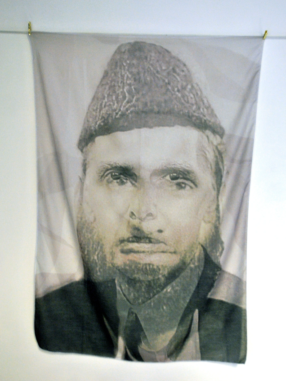 Black and white portrait of a man wearing a traditional hat.