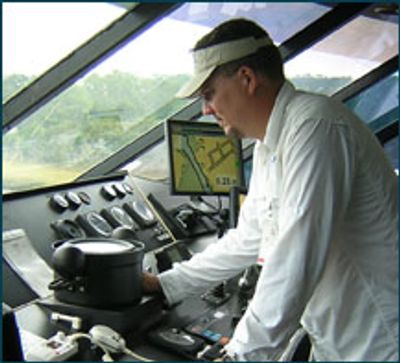 Asa Lassiter, owner of Island Compass South, adjusting a compass on a ship.