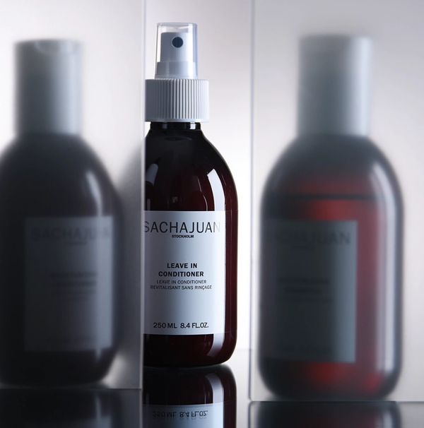 SACHAJUAN leave-in conditioner bottle with two blurred reflections.