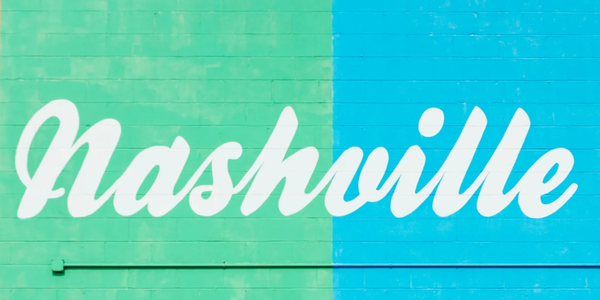 White 'Nashville' text on a blue and green wall.