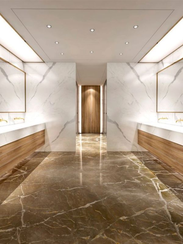 Luxurious modern restroom with marble floors and wood accents.