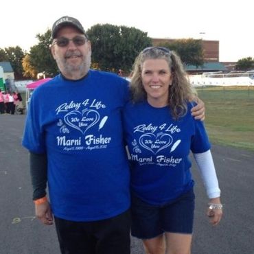 2 people walking for a fundraiser- one wearing GBL hat