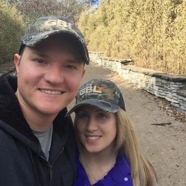 Couple in remote walkway wearing GBL hats