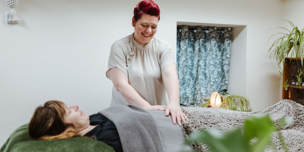 Katy giving Reiki to a client's tummy