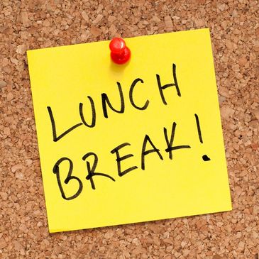 Yellow sticky note on corkboard saying 'LUNCH BREAK!'