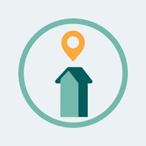 House with a location pin inside a circular frame.