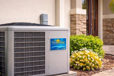 Residential air conditioning system installed outside home in Bee Ridge Florida.