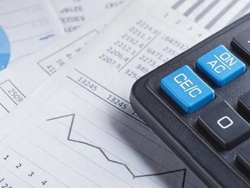 Calculator and data suggesting accounting needs