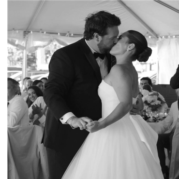 Newlyweds share a kiss during their wedding reception.