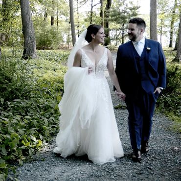 Bride and groom walking outdoors on wedding day.