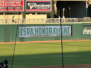 CSRA Honor Flight banner at a baseball field.