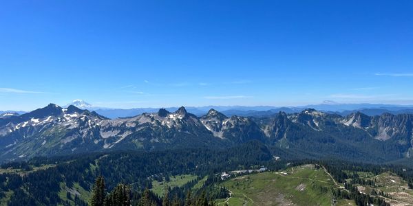 Clear mountain range under a bright blue sky.