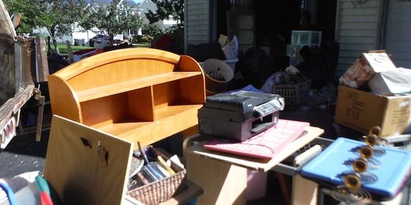 Driveway with a large amount of old furniture that we put into our Garbage Truck