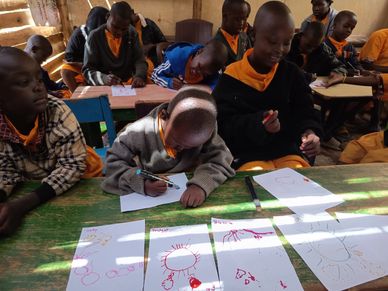 Children drawing and coloring in a classroom with sunlight streaming in.