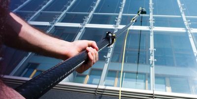 Water-fed pole on a large glass facade building can be done by The Upper Glass window cleaning.