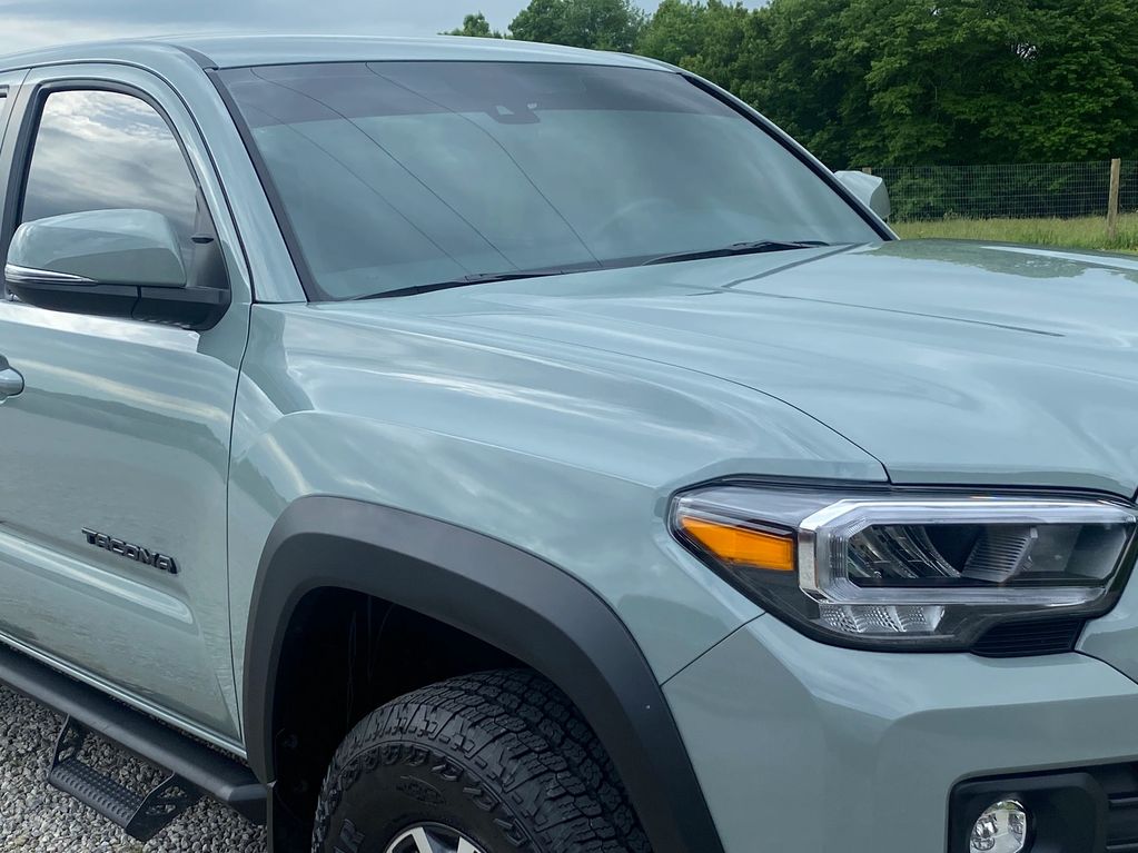 Light grey Tacoma truck front side with black trim.
