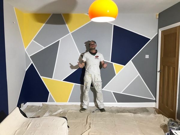 Me, Stuart, in front of a finished geometric Design Hand Painted wall