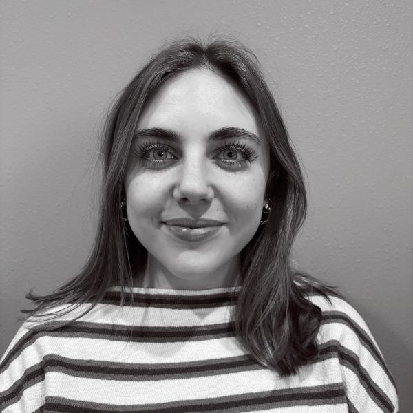 Young woman with a striped shirt smiling gently.
