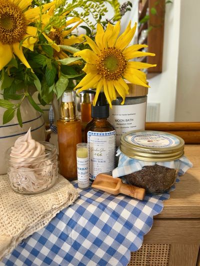 Sunflower and skincare products on a blue checkered cloth.