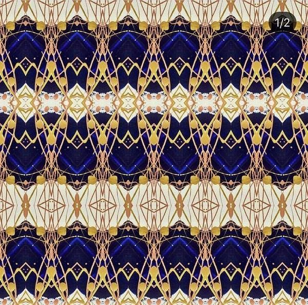 Intricate symmetrical pattern with gold, navy, and white colors.