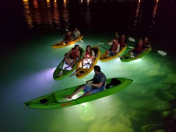 4 kayakers over a reef on the water at night with LED lights
www.glassbottomtours.com