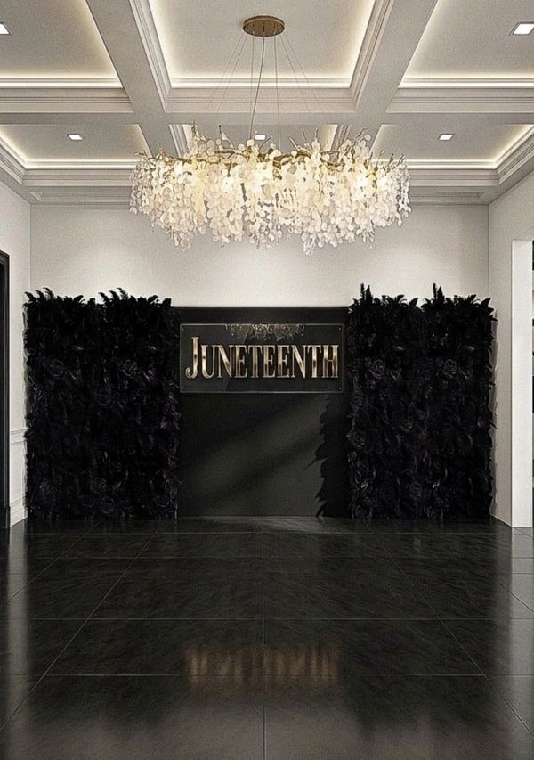 Elegant Juneteenth display with black floral walls and a chandelier.