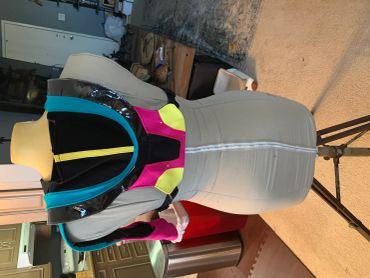 Colorful, futuristic costume piece displayed on a mannequin.