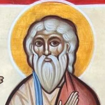 Iconic painting of three saints with halos, holding symbolic items like a sword and ladder.