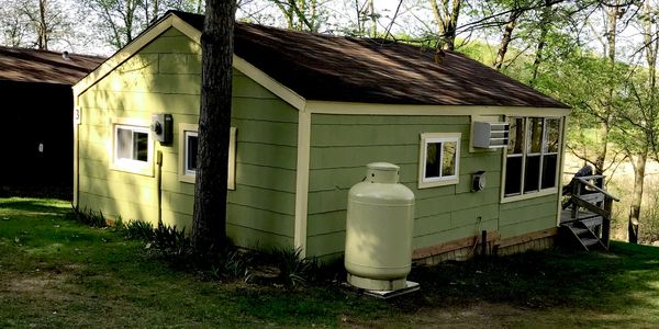 A picture of a wooden cabin captured from the posterior side