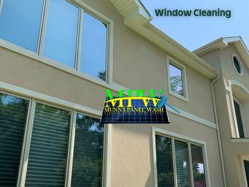 Home window being cleaned with deionized water by Munn's Panel Wash for streak-free results.